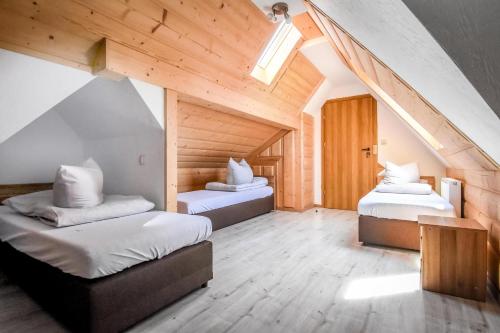 two beds in a room with an attic at Willa Stołowianka- Basen in Bukowina Tatrzańska