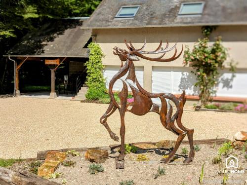 a bronze statue of a deer in front of a house at Les Charmes - Climatisation - Terrasse - Nature in Boigny-sur Bionne