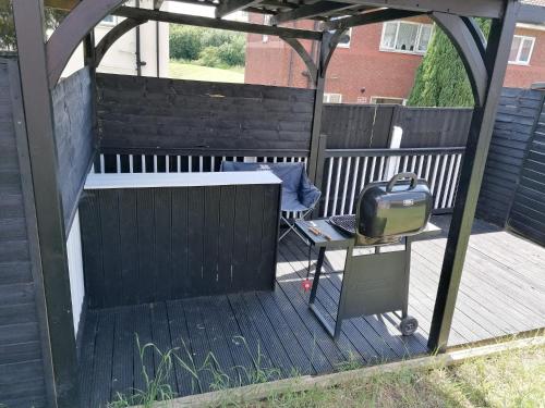 a wooden deck with a gazebo and a television at Affluent Living Property perfect for contractors and individuals in Wigan