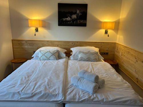 a white bed with towels on it in a bedroom at Sprungschanze Haus in Murau