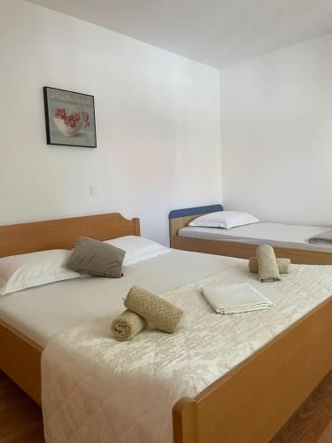 two beds in a small room with two beds at APP Mirela 3 in Novi Vinodolski