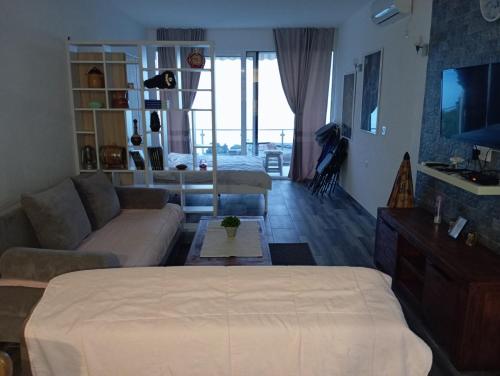 a living room with a couch and a tv at Zara by the sea in Brca