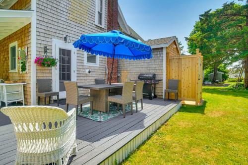 a patio with a table and chairs and an umbrella at Walk to 2 Beaches Pocasset Home with Kayaks and Bikes in Pocasset