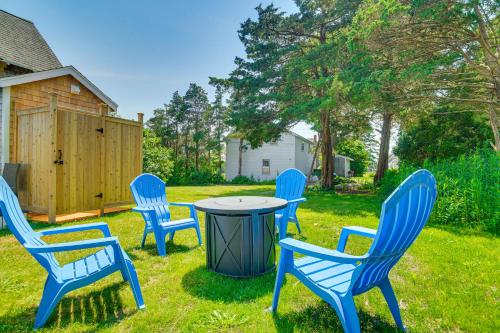 a group of blue chairs around a table in a yard at Walk to 2 Beaches Pocasset Home with Kayaks and Bikes in Pocasset