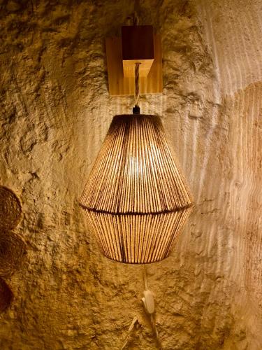 a lamp hanging from a wall in a room at Casa di Pietra in Crispiano