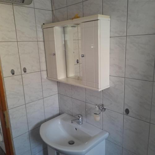 a bathroom with a sink and a medicine cabinet at Makri Vacation House in Alexandroupoli