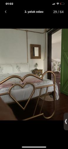 a bedroom with a bed with a metal frame at Maison Arzu & Mebrure in Gokceada Town