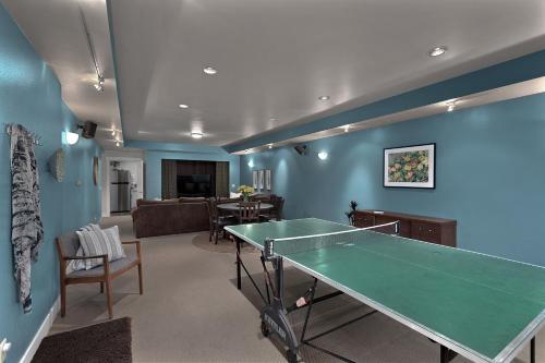 a living room with a ping pong table in it at Hot Tub Family Friendly Garden City Getaway in Missoula