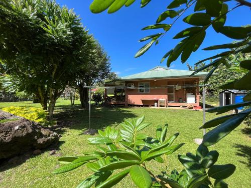 a house in a yard with trees and grass at FARE ARIKI MOOREA in Afareaitu