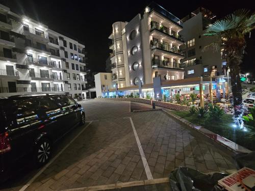 a car parked in a parking lot next to some buildings at Vienna Luxury Apartments in Dobra Voda