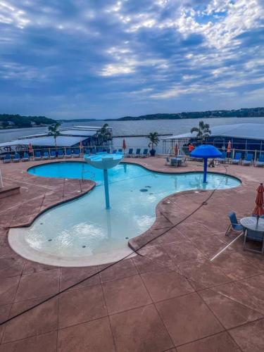 a large swimming pool with a view of the water at Beautiful Lakeside Oasis in Rocky Mount