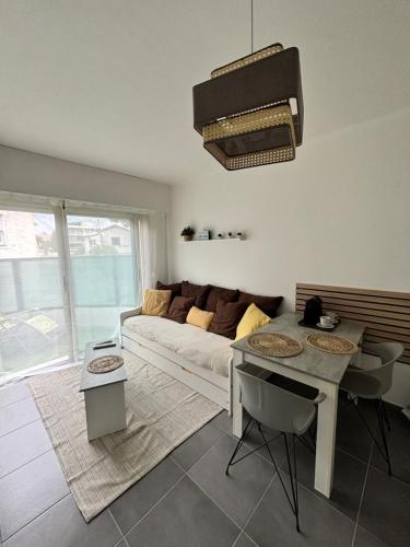 un salon avec un canapé et une table dans l'établissement Beau STUDIO HIPPODROME MER PLAGE, à Cagnes-sur-Mer