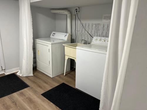 a laundry room with a washing machine and a washer at Cozy basement 2 bedroom 2 bath with parking in Richmond Hill