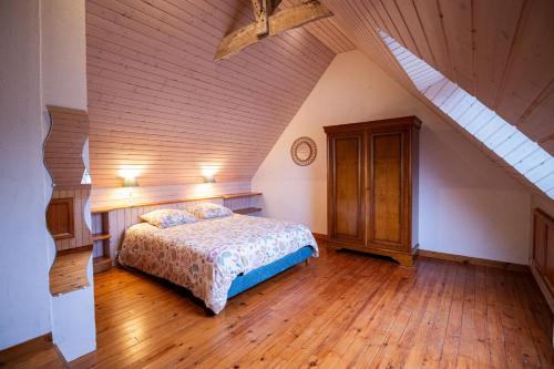 a bedroom with a bed in a attic at la Métairie du Grand Ker in Plougasnou