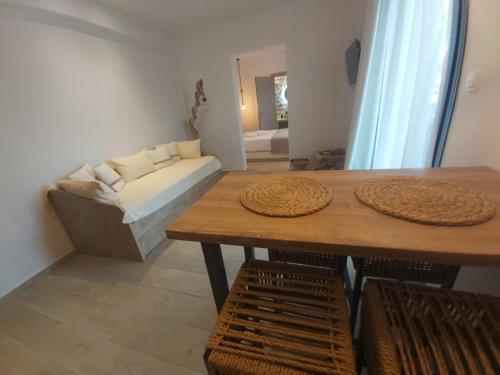 a living room with a table and a couch at House Karga in Ormos Panagias