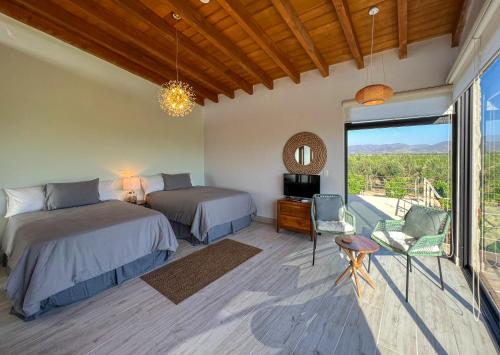 a bedroom with two beds and a balcony at Valle Soléa in El Porvenir