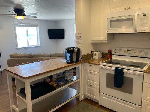 a kitchen with white cabinets and a wooden counter top at Bryce Vistas in Tropic