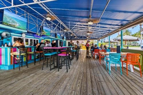 a restaurant with colorful tables and chairs on a pier at Ocean View Hotel Room with Balcony- King Bed #21 in Fort Pierce
