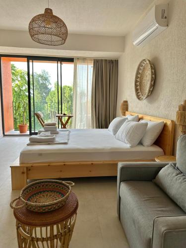 a bedroom with a large bed and a couch at Rue Rooms in Fethiye