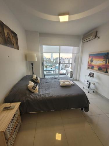 a bedroom with a large bed and a large window at Hermoso 1amb Lindo SuperCompleto in Buenos Aires