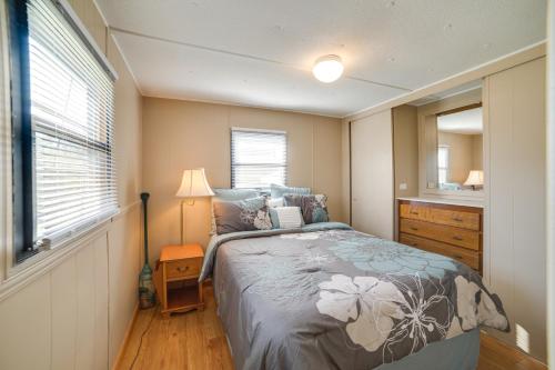 a bedroom with a bed and a dresser and a window at Waterloo Home Walk to Pickwick Lake Fishing Pier! in Waterloo