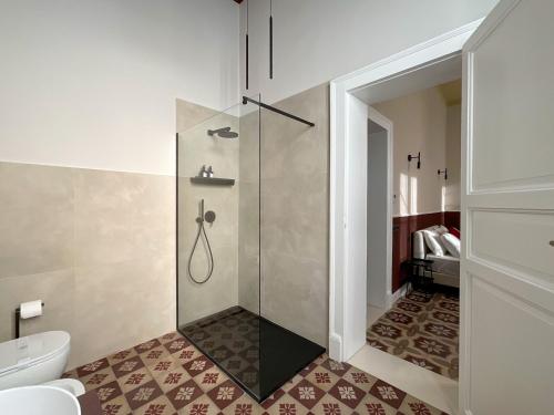 a bathroom with a shower and a toilet at Maison Ines Luxury B&B in Messina