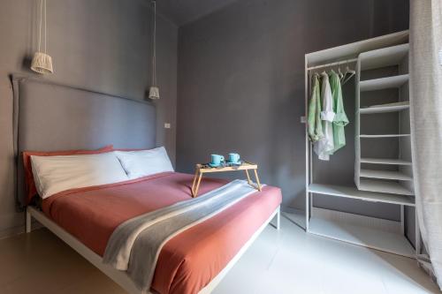 a bedroom with a bed with a table and a closet at Via Fieschi dieci in Genova