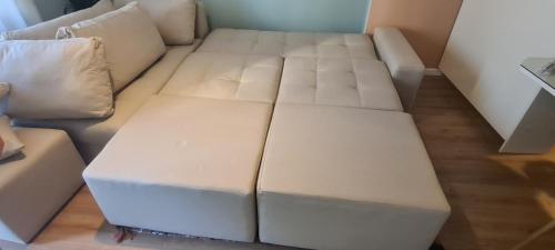 a white couch sitting in a living room at LA Comfy AP in Sarandë