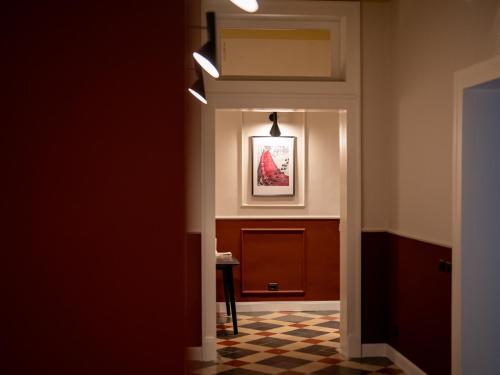 a hallway leading to a room with a picture on the wall at Maison Ines Luxury B&B in Messina
