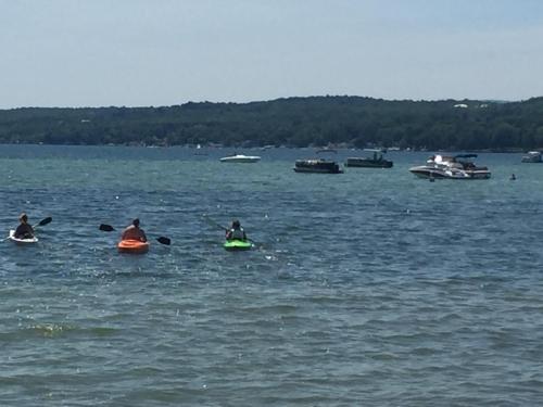 a group of people on kayaks in a body of water at Water's Edge on Canandaigua Lake 2 bedroom only October 15-April 30 El Borde del Agua de Canandaigua in Canandaigua