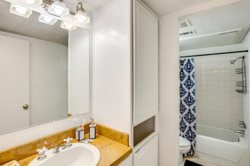 a bathroom with a sink and a mirror at Dallas Condo in Walkable Knox Street District! in Dallas
