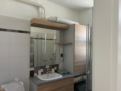 a bathroom with a sink and a shower at Jó hely in Balatonalmádi