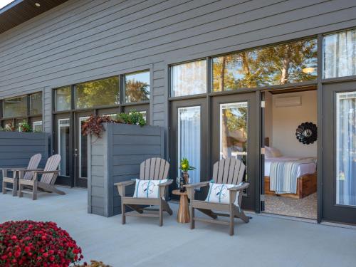 a patio with two chairs and a bed in a bedroom at Pebble Bay Club Suites in Camdenton