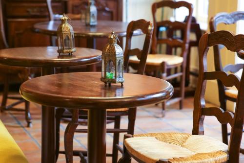 a group of wooden tables and chairs with lanterns on them at Petite Auberge in San Francisco