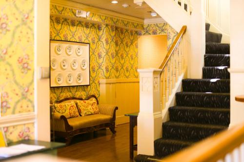 a stairway with a chair and a stair case at Petite Auberge in San Francisco