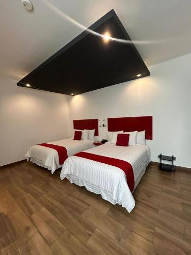 Postel nebo postele na pokoji v ubytování Zújmú Business Boutique Hotel