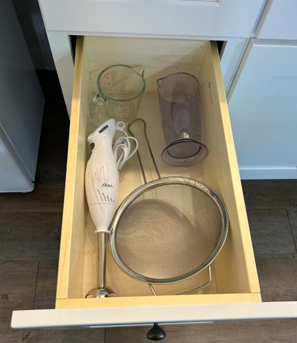 a box with a whisk and various appliances in it at Chic Romantic3bed patio WIFI quiet retreat parking in Calgary