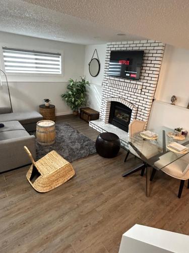 a living room with a couch and a fireplace at Chic Romantic3bed patio WIFI quiet retreat parking in Calgary