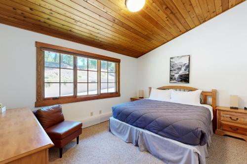 a bedroom with a bed and a wooden ceiling at Bay Point Hillside 15D in Whitefish