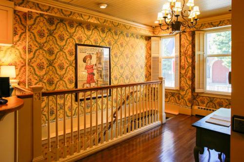 a staircase in a home with wallpaper at Petite Auberge in San Francisco