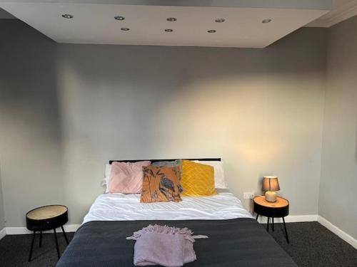 a bedroom with a bed with two tables and two chairs at Berridge House in Nottingham