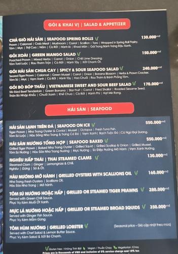 a menu on the wall of a restaurant at The KH Cam Ranh Nha Trang Beachside in Thôn Hòa Ða