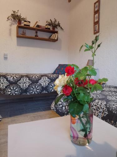 a living room with a vase with flowers on a table at Casa Villa Alba Carpinteria in Carpintería