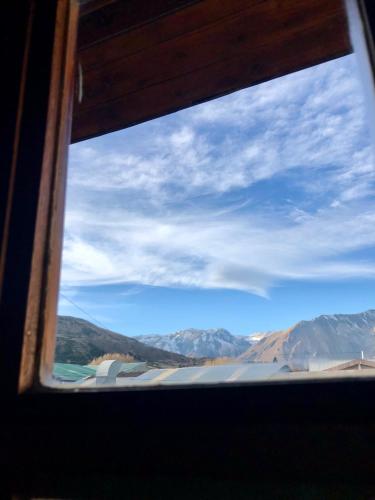 a view of the mountains from a window at Casa andina in Esquel