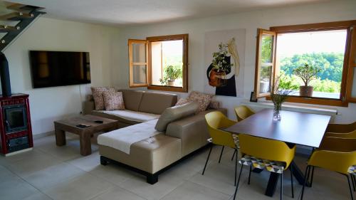 a living room with a couch and a table at Silver Juglans Holiday Home in Čazma