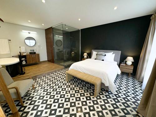 a bedroom with a bed and a glass shower at Casa Martina Guest House in Pátzcuaro
