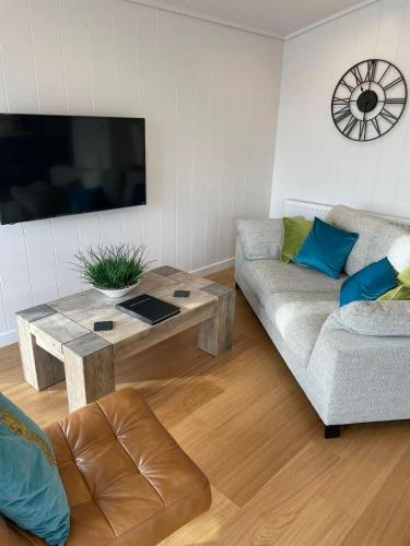 a living room with a couch and a coffee table at Pettico Lodge in Eyemouth