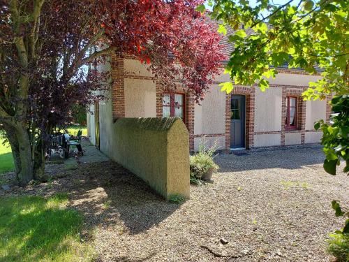 a stone wall in front of a building at Charmante Maison Rénovée avec Jardin, BBQ et Loisirs à La Saucelle - FR-1-581-13 in La Saucelle