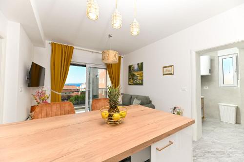 a kitchen with a table with a vase on it at Apartments Diva in Trogir