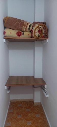 a shelf in a wall with a bed on it at Residence Yasamine Ain El Turck in 'Aïn el Turk